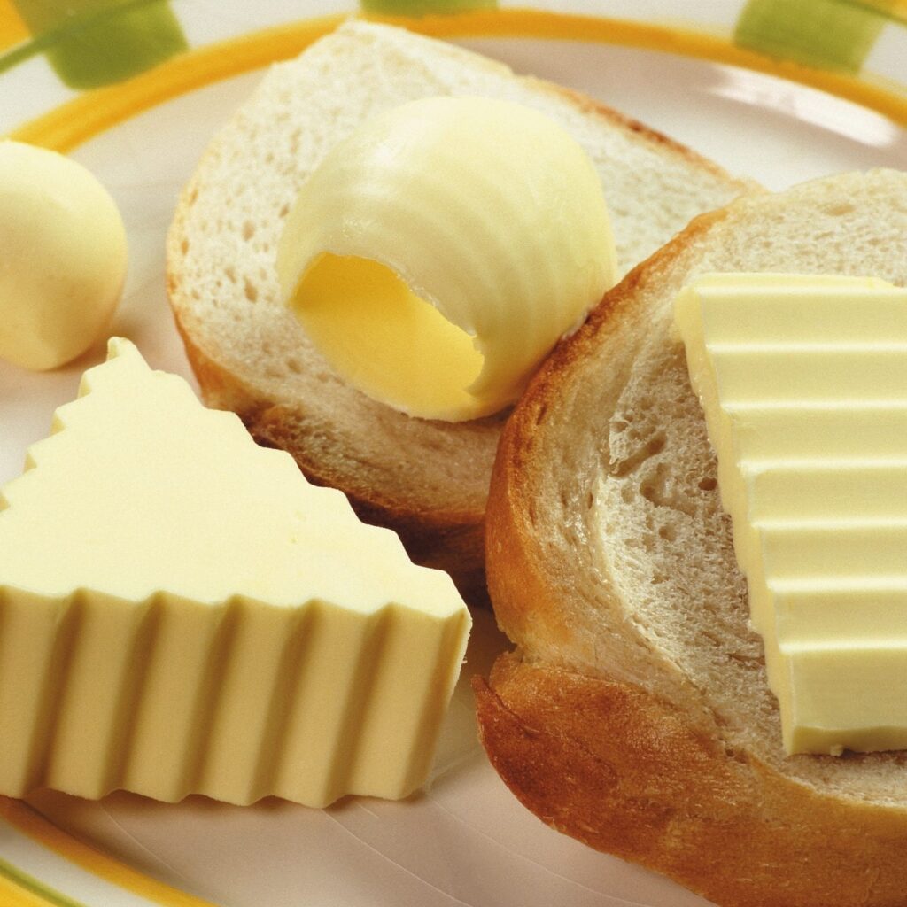 A selection of butter, jams, and marmalade for the toast.
